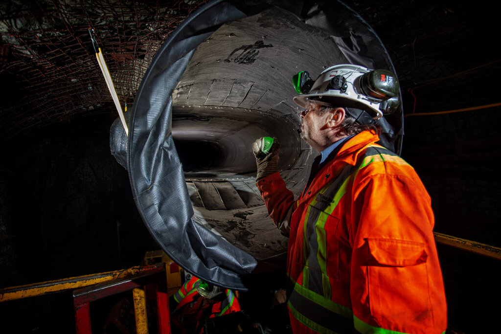Miner looking at underground tunnel