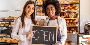Women with a Business Open Sign