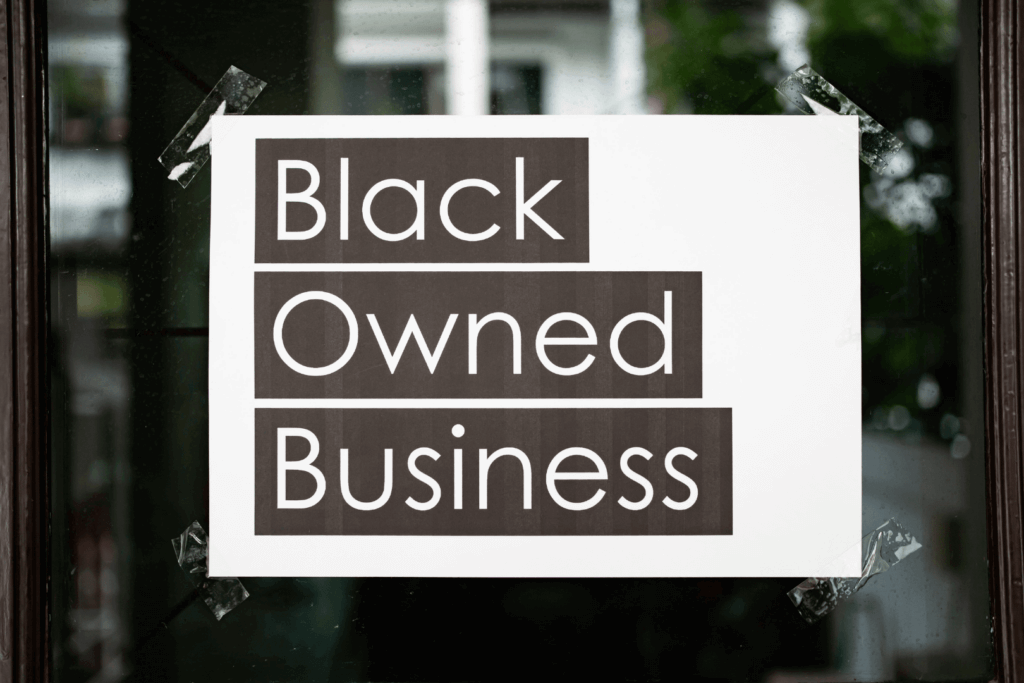 A sign on a store window that says "Black Owned Business"