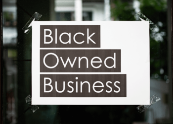 A sign on a store window that says "Black Owned Business"